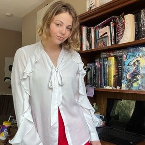 Small white blouse with ruffles and bow